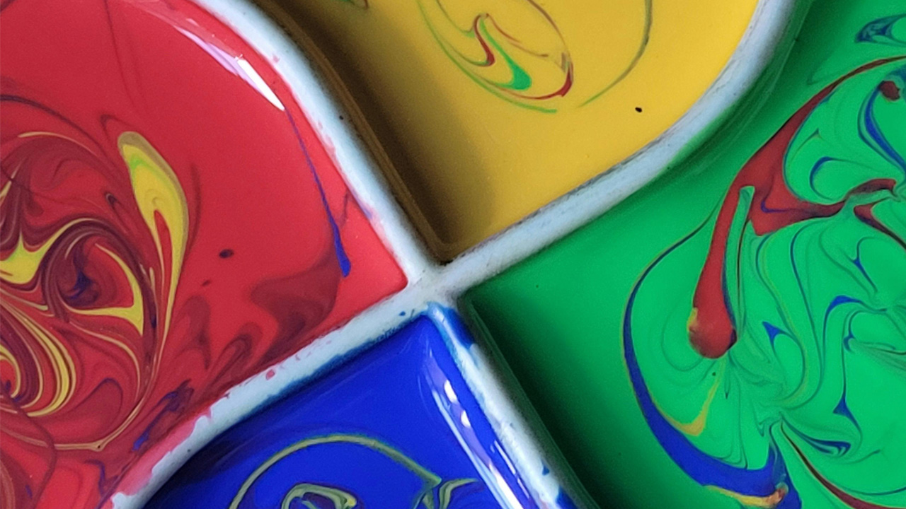 Cross section of colours in paint container.